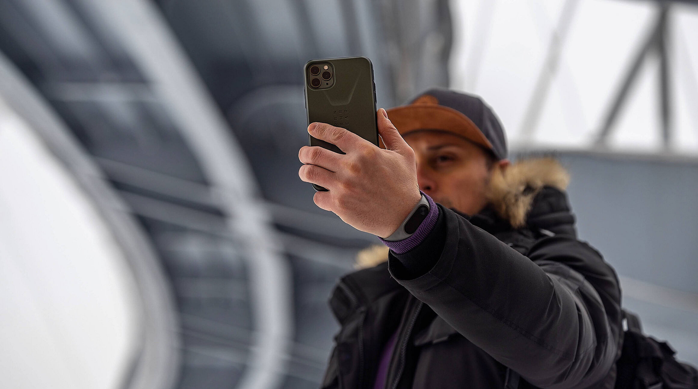 Man using a smartphone under the Eiffel Tower