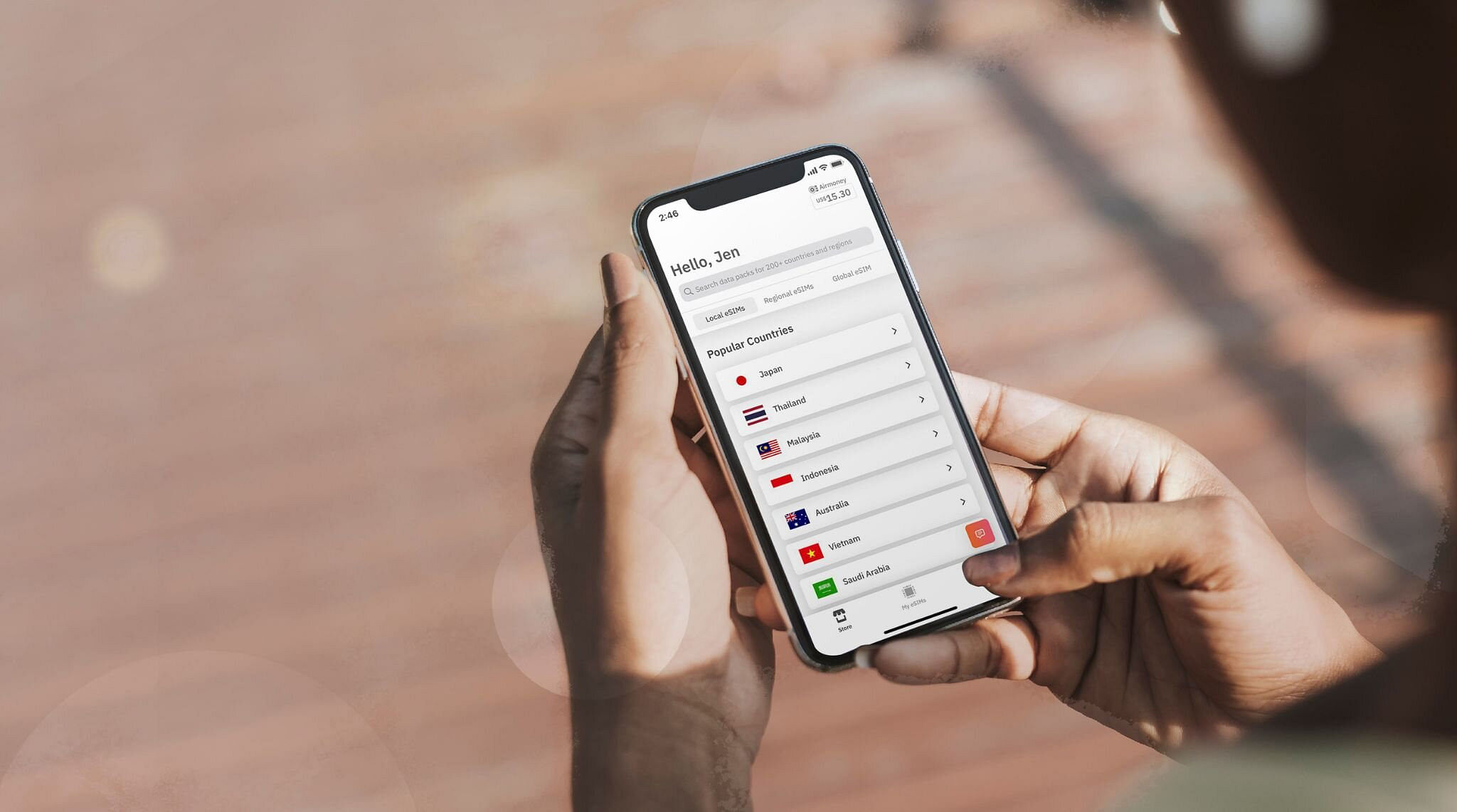 Woman holding iPhone with Airzalo app displaying eSIMs 